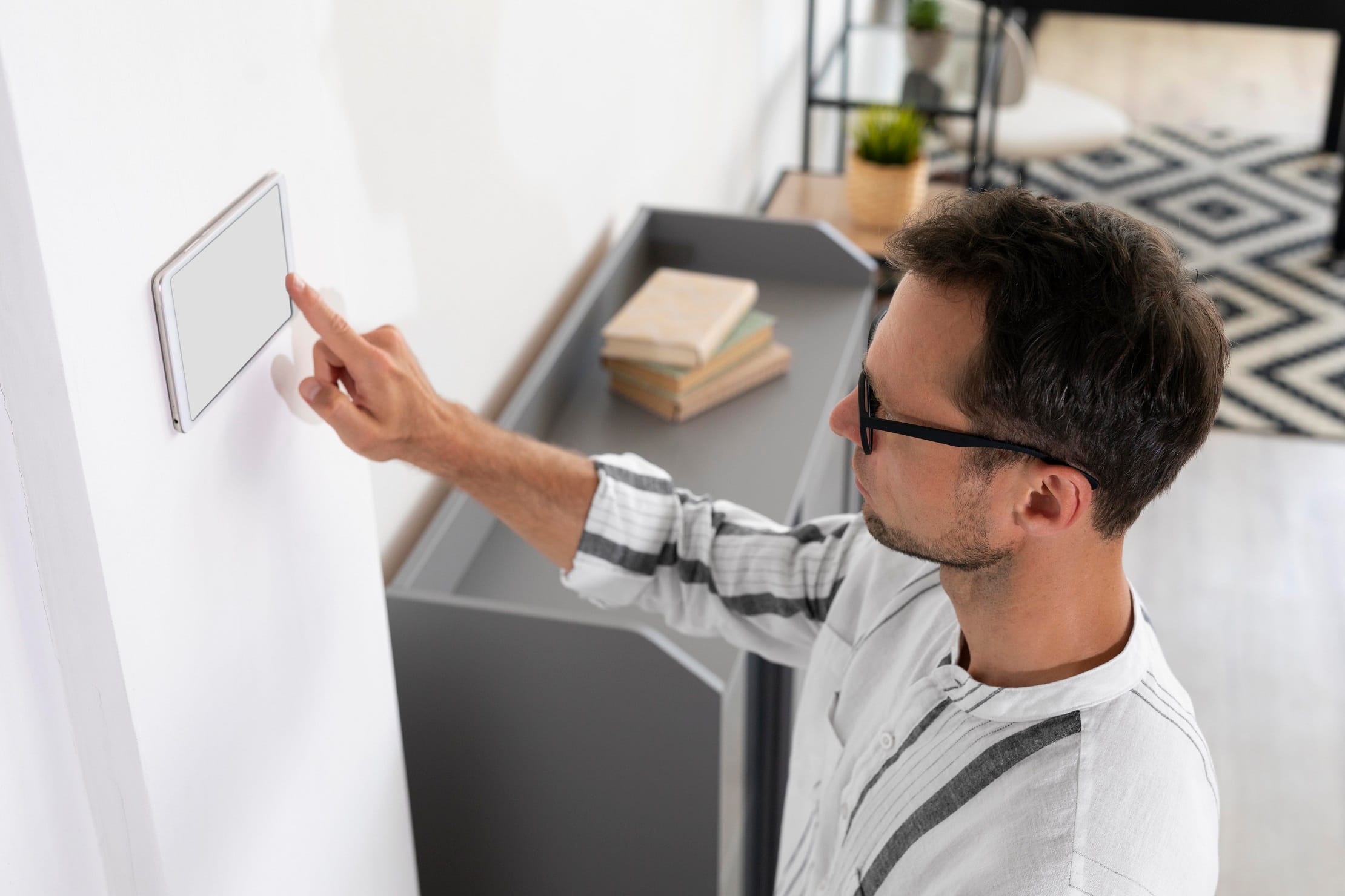 man-using-smart-home-tablet